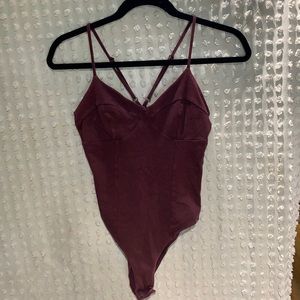 A made Brand size XS burgundy body suit with cup support adjustable strap